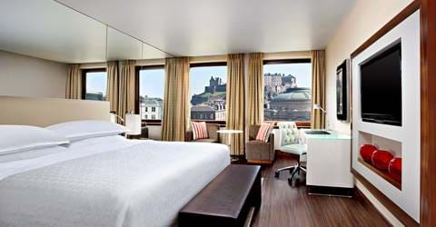 Bedroom at the Sheraton Grand Hotel & Spa with a view of Edinburgh Castle.