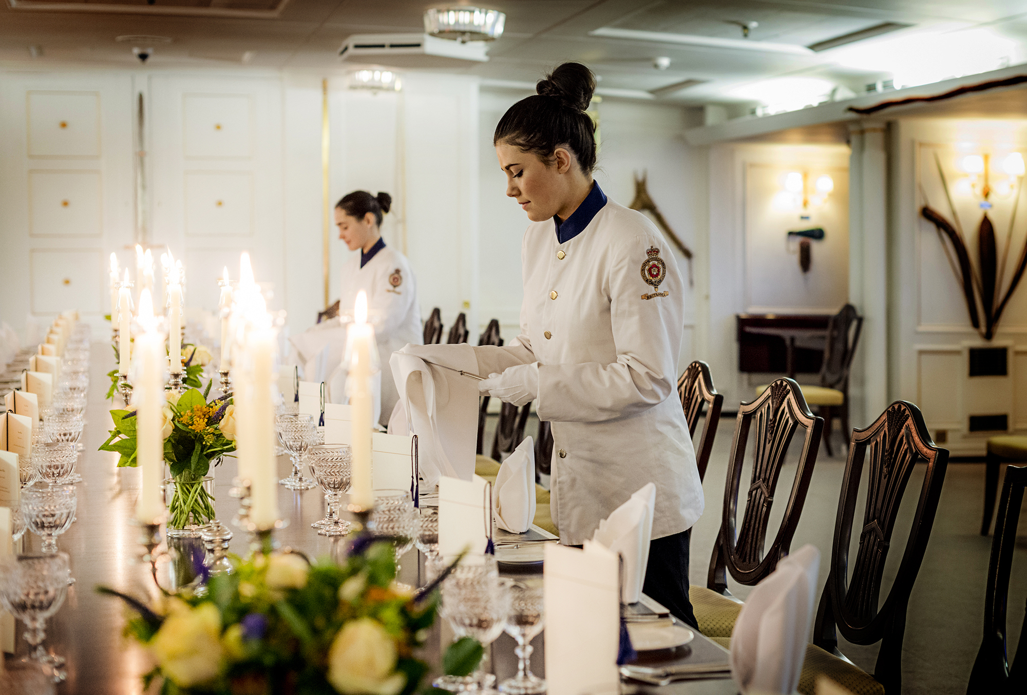 Tables being set for fine dining on the Royal Yacht Britannia