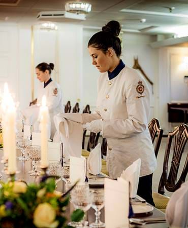 Tables being set for fine dining on the Royal Yacht Britannia