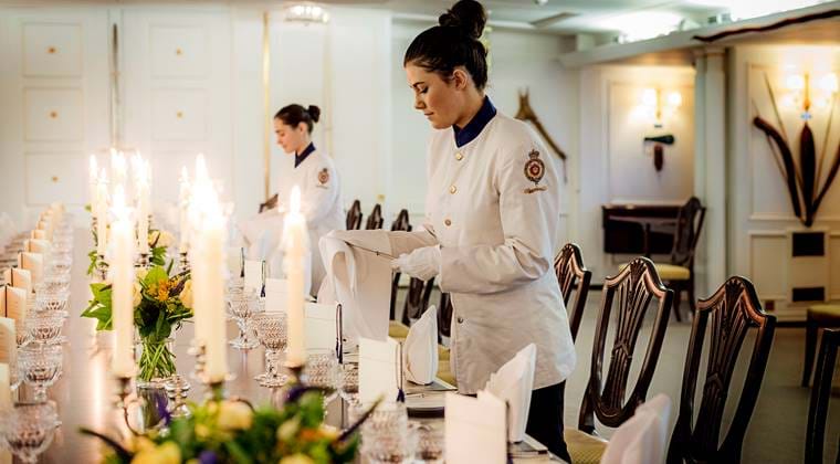 Tables being set for fine dining on the Royal Yacht Britannia