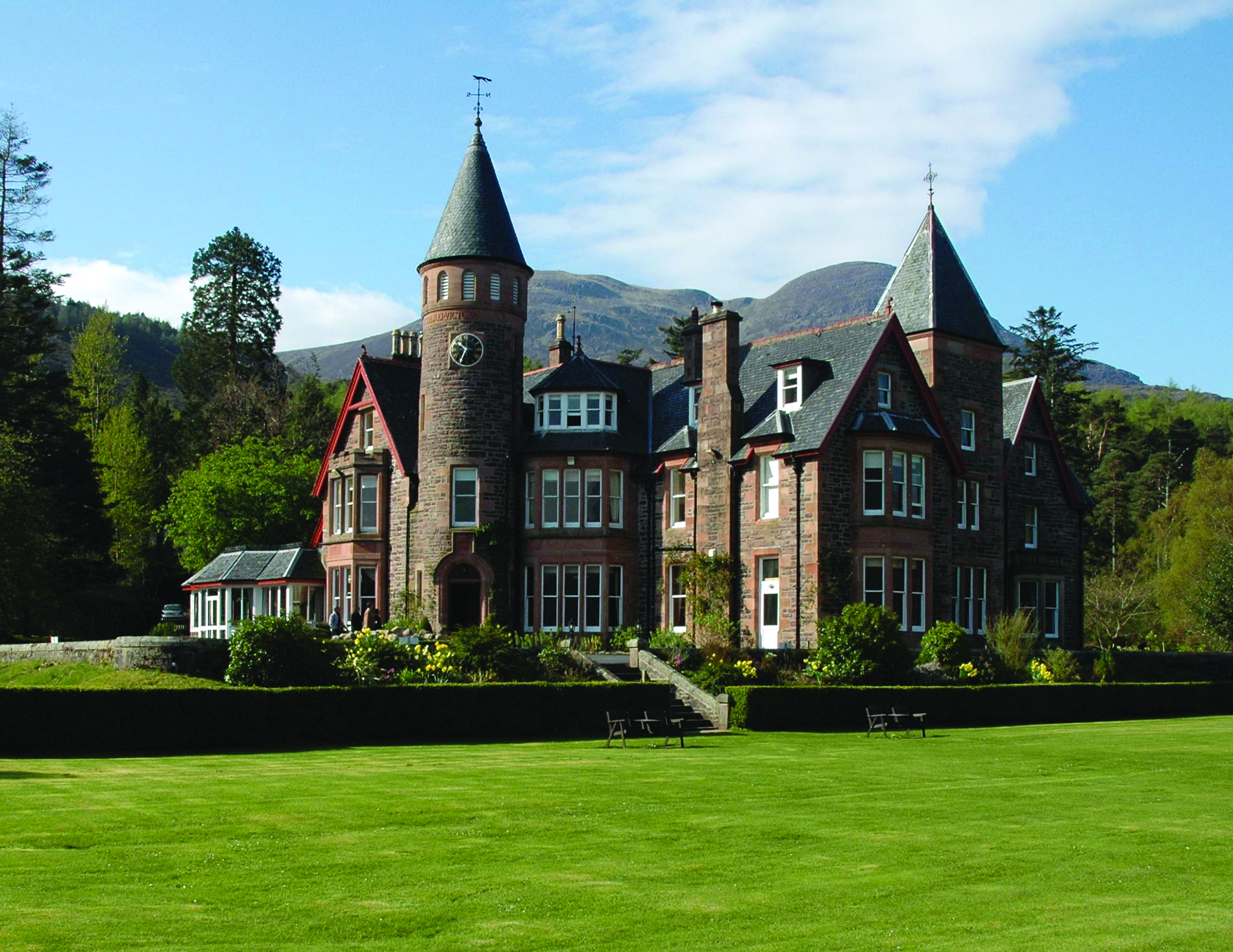 View of lawn and exterior of The Torridon, the famous castle hotel in the Scottish Highlands.in 