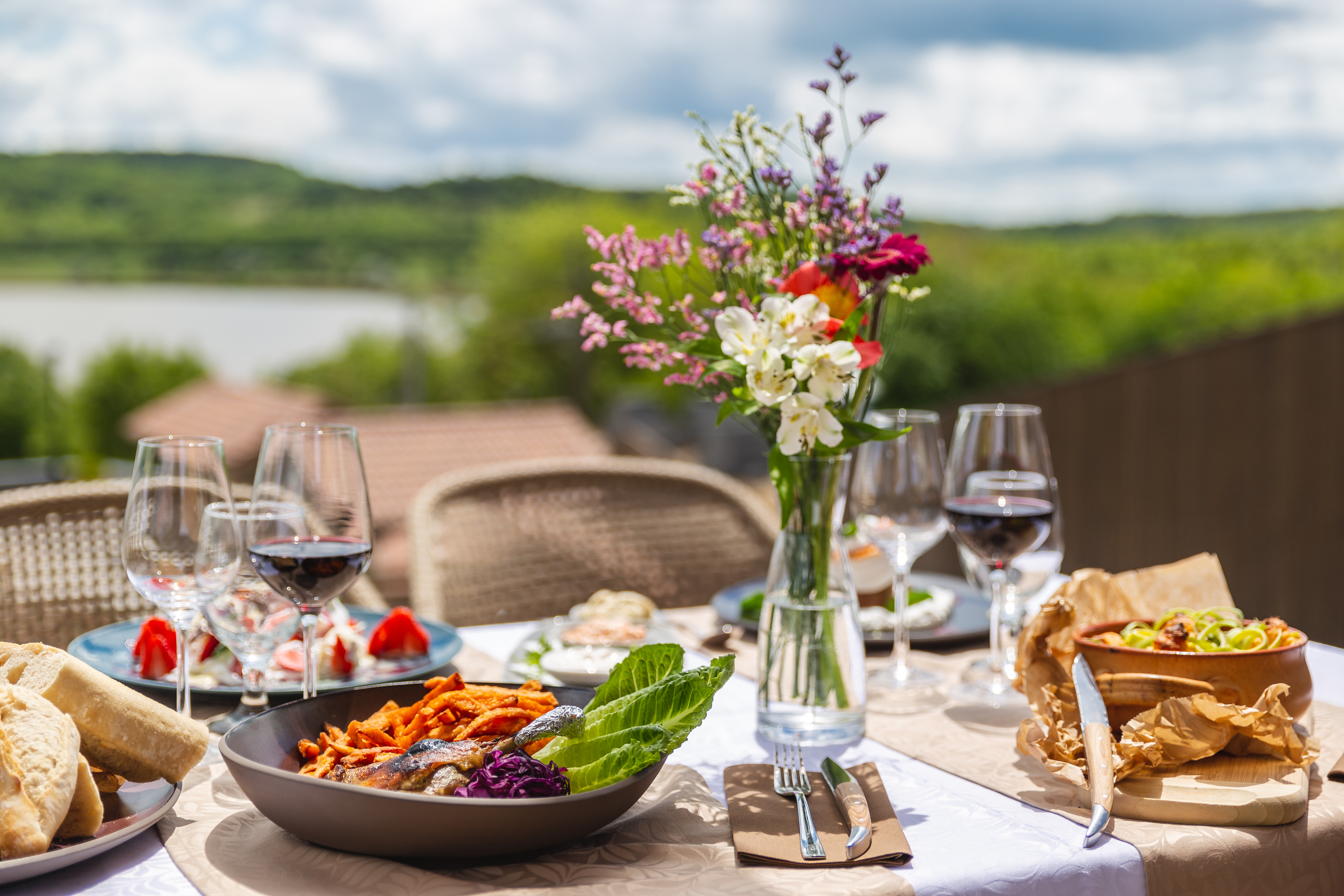 Table set with food and a vase of flowers