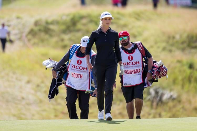 Woman golfer with caddies