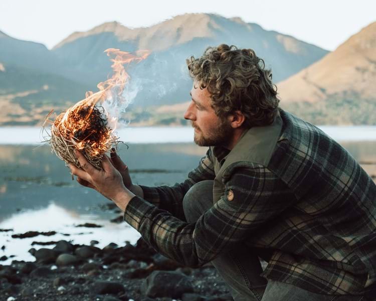 Man starting a fire in the wild